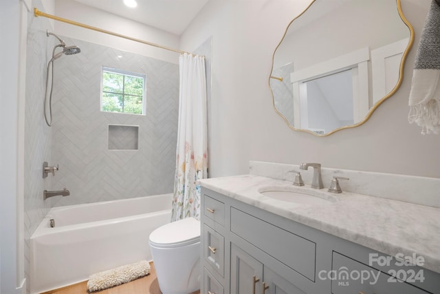 full bathroom featuring shower / tub combo, vanity, and toilet