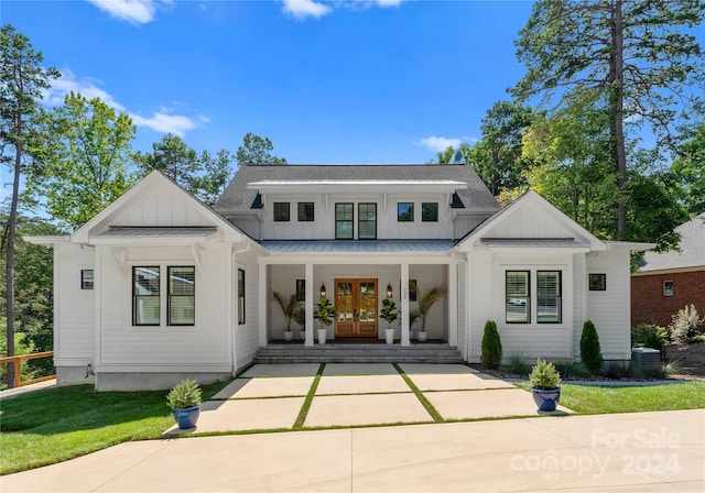 rear view of house featuring a porch and french doors