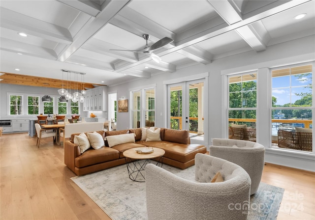 sunroom / solarium with ceiling fan, beam ceiling, and french doors