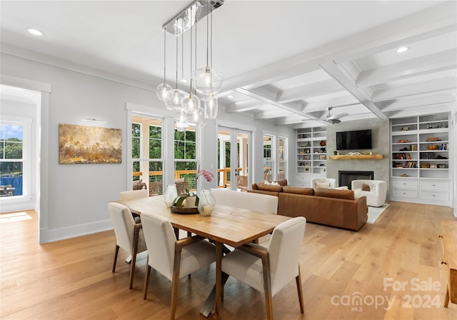 dining room featuring french doors, coffered ceiling, light wood-type flooring, built in features, and beam ceiling