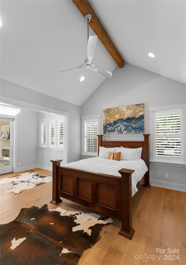 bedroom with vaulted ceiling with beams, light wood-type flooring, and ceiling fan