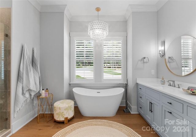 bathroom featuring ornamental molding, hardwood / wood-style flooring, and a notable chandelier