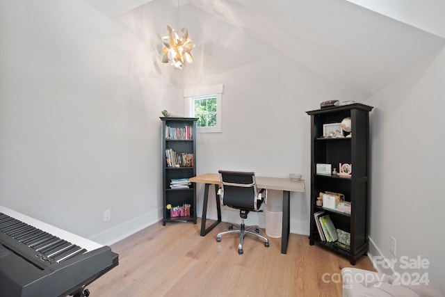 office with light hardwood / wood-style flooring, vaulted ceiling, and an inviting chandelier