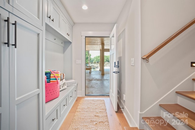 mudroom with light hardwood / wood-style floors