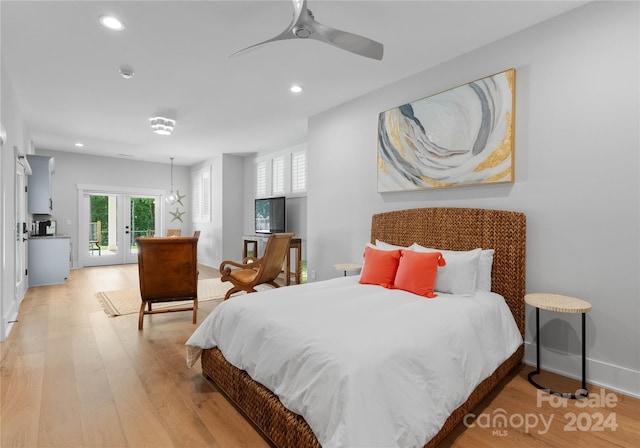 bedroom featuring access to exterior, french doors, light wood-type flooring, and ceiling fan