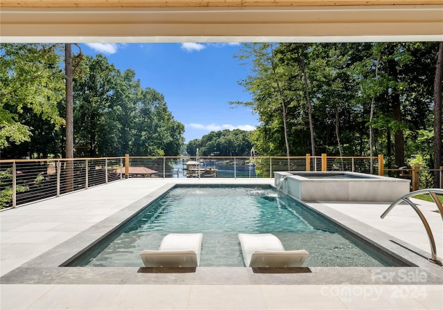 view of swimming pool with pool water feature, a patio area, and an in ground hot tub