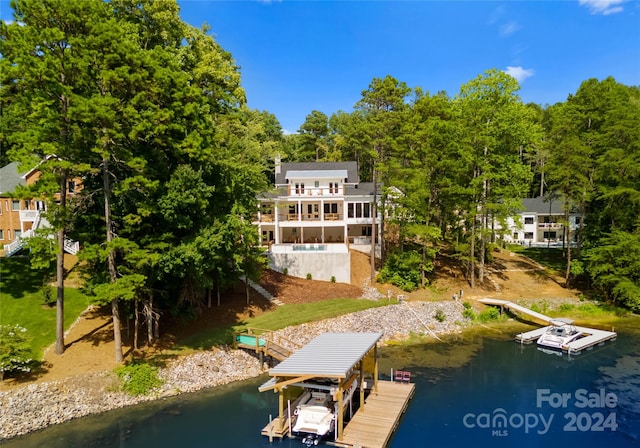 view of dock with a water view and a balcony