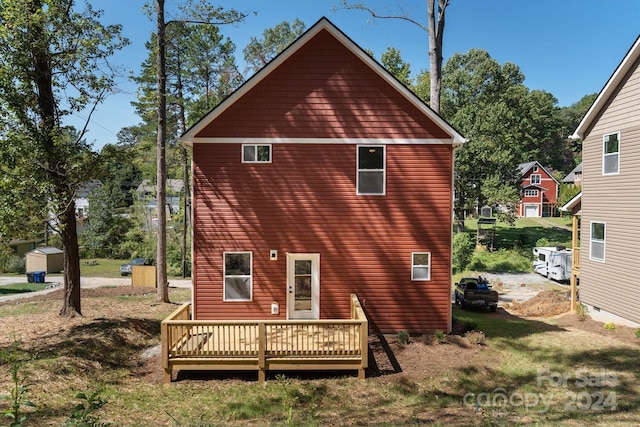 back of house featuring a wooden deck