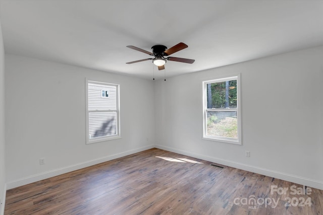 unfurnished room featuring hardwood / wood-style floors and ceiling fan