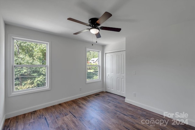 unfurnished room with ceiling fan and dark hardwood / wood-style floors