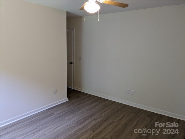 empty room with dark wood-type flooring and ceiling fan