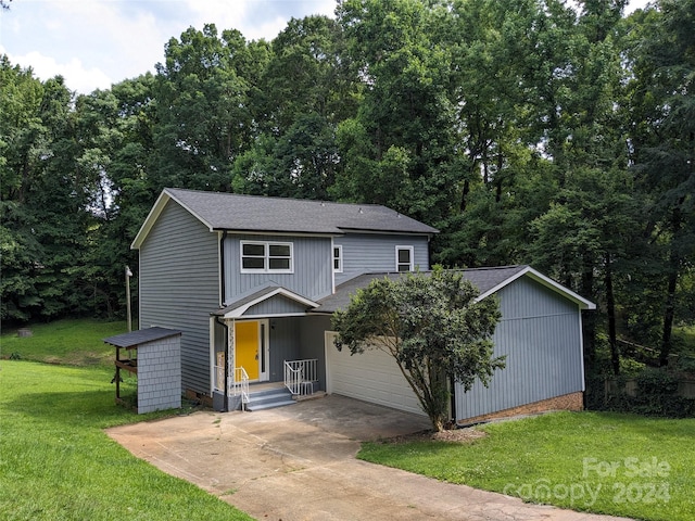 front of property with a front lawn and a garage