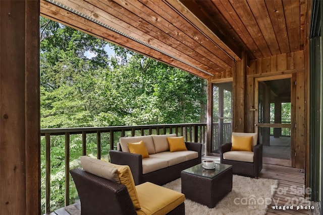 sunroom / solarium featuring wooden ceiling and vaulted ceiling