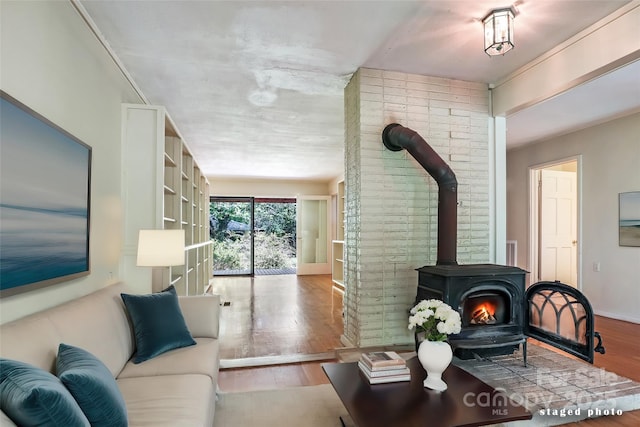 living room with light wood-type flooring and a wood stove