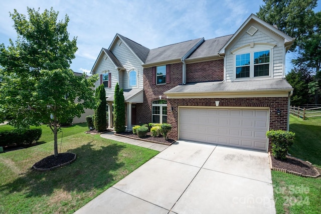 view of front facade with a front yard and a garage