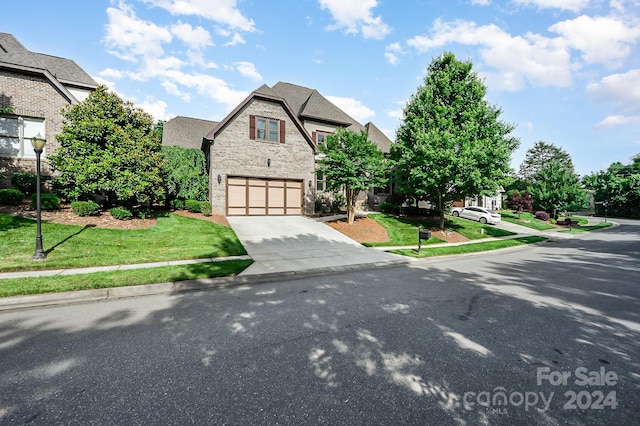 view of front facade with a front yard and a garage