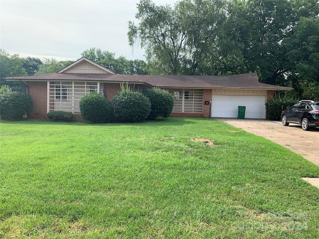 ranch-style home with a garage and a front lawn