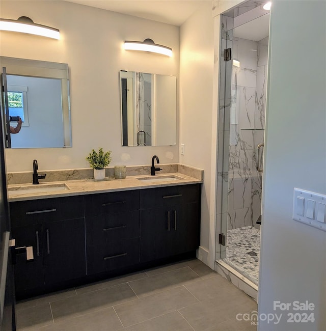 bathroom with vanity, tile patterned flooring, and a shower with door