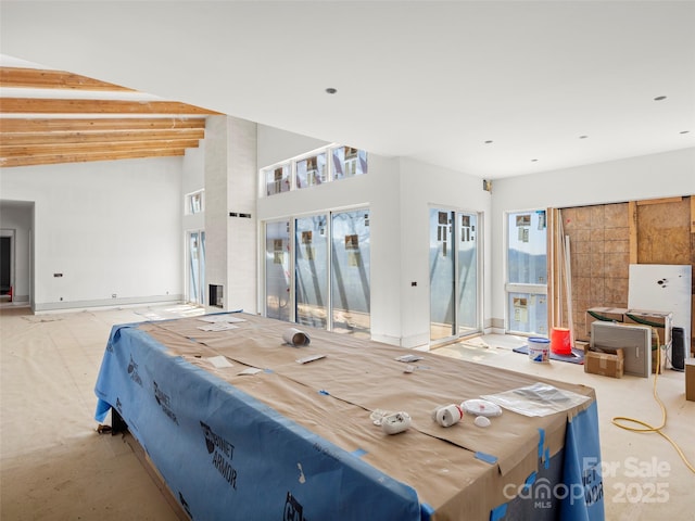 bedroom featuring access to outside and baseboards
