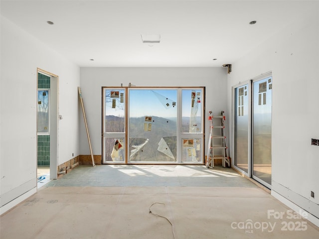 empty room with concrete flooring