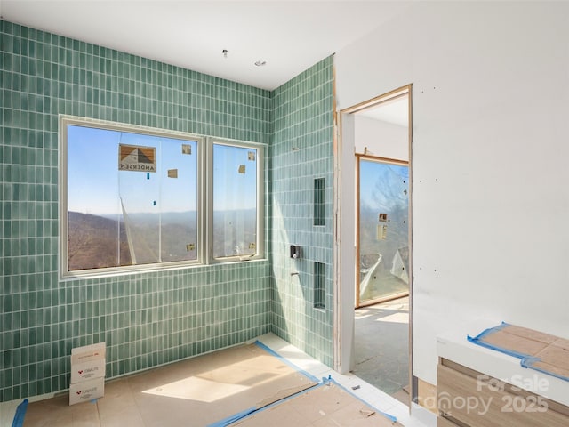 bathroom with tile walls