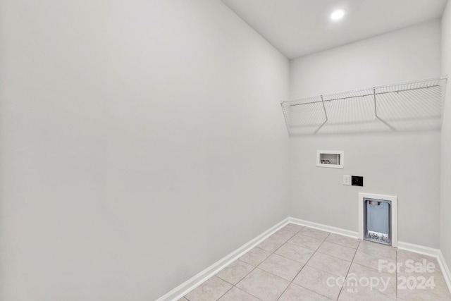 washroom featuring light tile patterned flooring and washer hookup