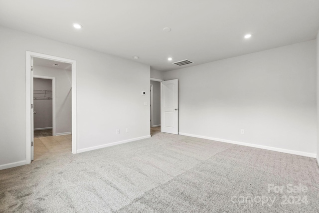 spare room featuring light colored carpet