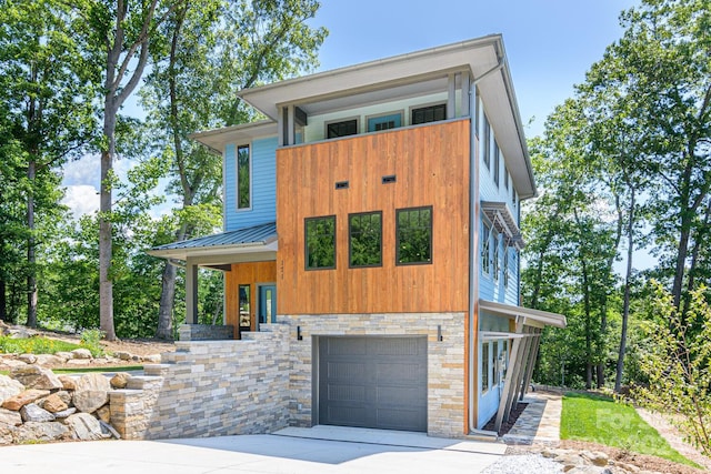 contemporary home with a balcony and a garage