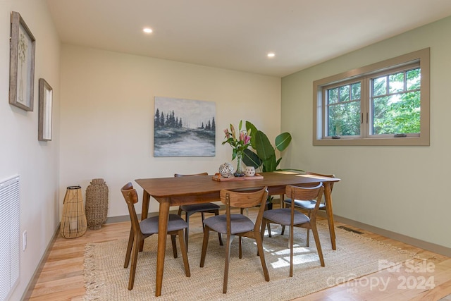 dining space with light hardwood / wood-style flooring