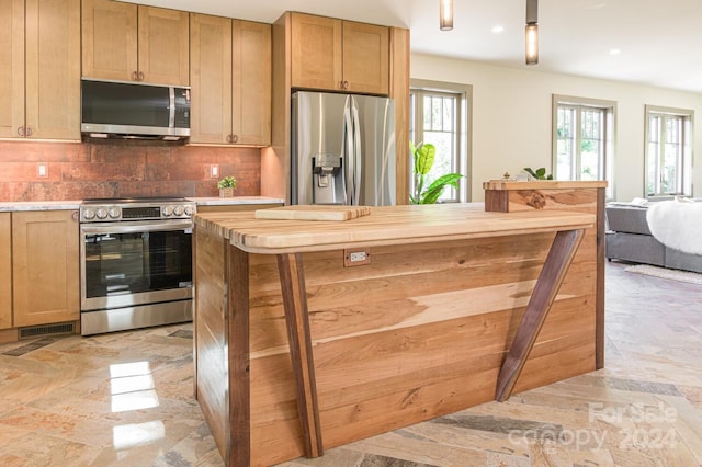 kitchen with decorative backsplash and appliances with stainless steel finishes