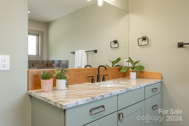 bathroom with vanity and decorative backsplash