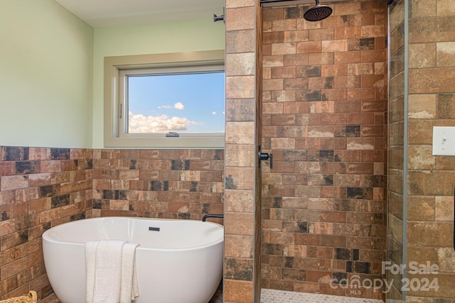 bathroom featuring separate shower and tub