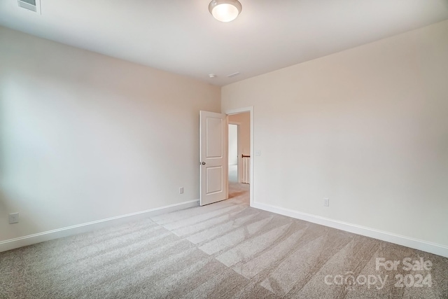 unfurnished room with light carpet