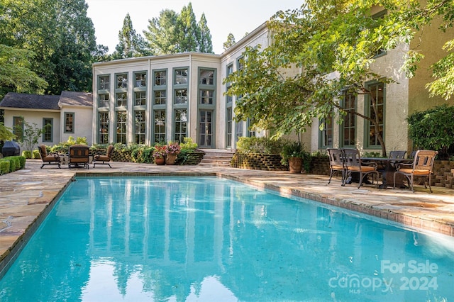 view of pool featuring a patio