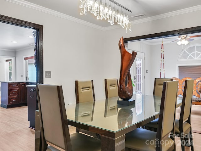 dining space with ceiling fan, light wood-type flooring, and crown molding