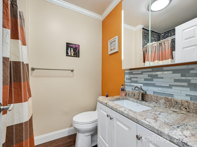 bathroom featuring wood-type flooring, vanity, backsplash, toilet, and crown molding