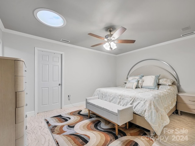 bedroom with ceiling fan and crown molding