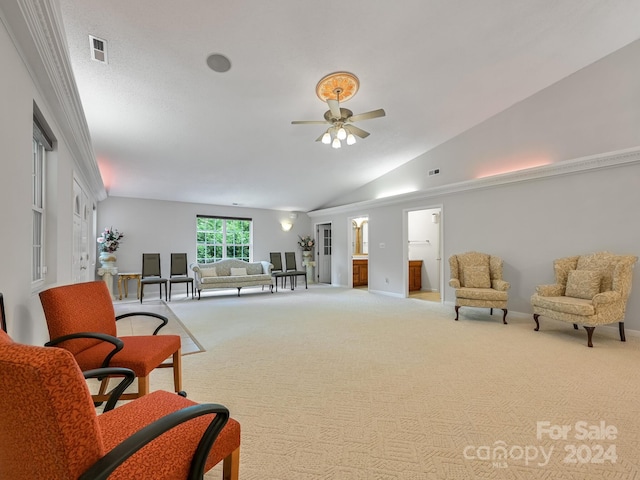 carpeted living room with ceiling fan, crown molding, and lofted ceiling