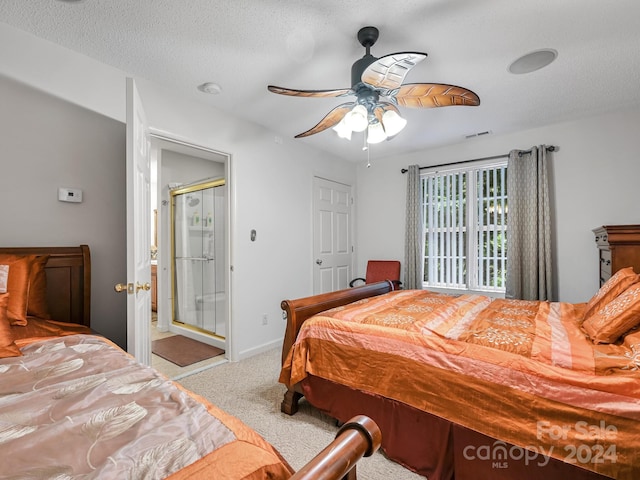 carpeted bedroom with ceiling fan and a textured ceiling