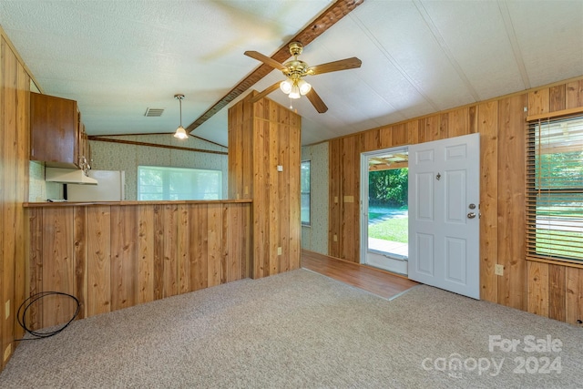 foyer featuring ceiling fan, a healthy amount of sunlight, carpet floors, and vaulted ceiling