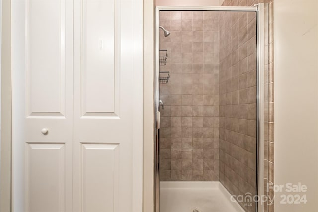 bathroom with a shower with shower door