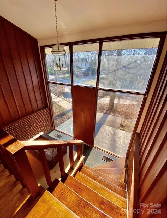 stairway featuring an inviting chandelier