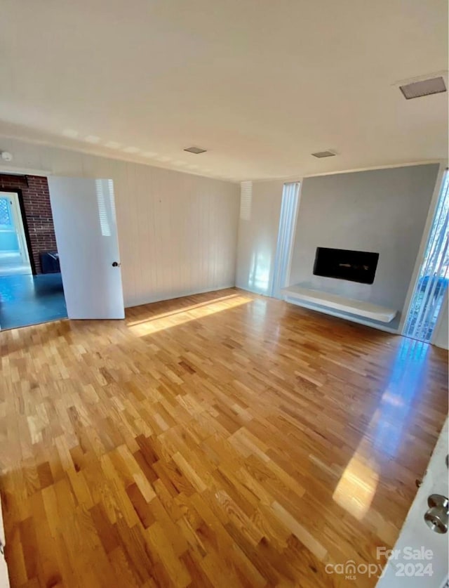 unfurnished living room with plenty of natural light and wood-type flooring