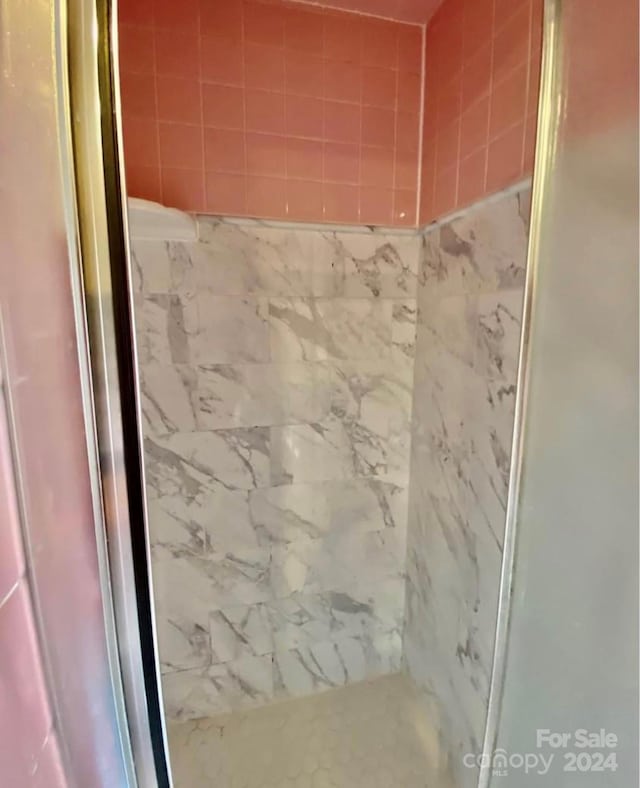 bathroom with tiled shower