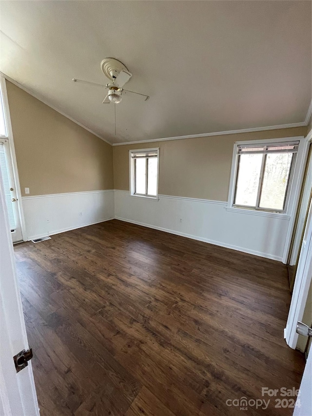 spare room featuring ornamental molding, ceiling fan, and dark wood-type flooring