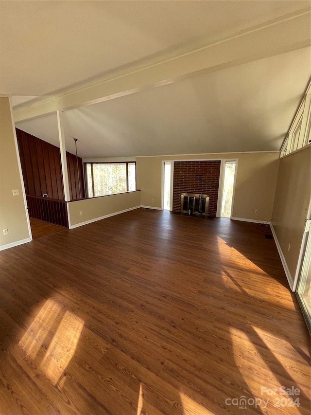 unfurnished living room featuring a fireplace, dark wood-type flooring, and lofted ceiling with beams