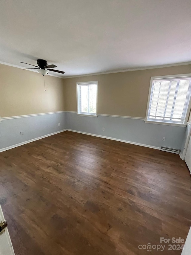 spare room with ceiling fan, ornamental molding, and dark wood-type flooring