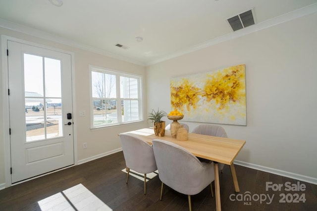 dining area featuring dark hardwood / wood-style flooring and crown molding