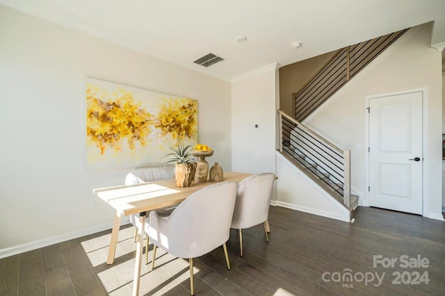 dining room featuring dark hardwood / wood-style flooring and ornamental molding