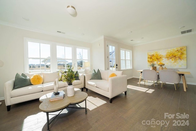 living room featuring crown molding, plenty of natural light, and dark wood-type flooring